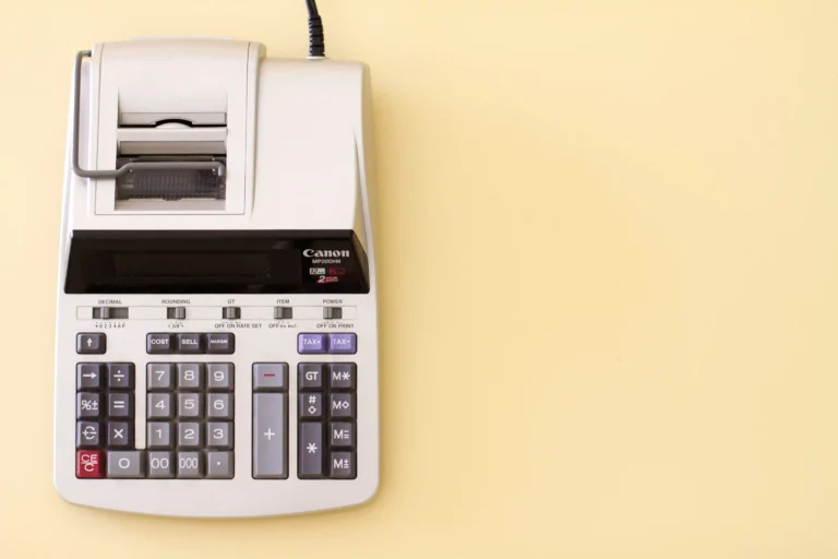 A Canon calculator on a yellow table