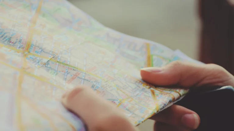 a hands holding a map to choose where the restaurant should be located