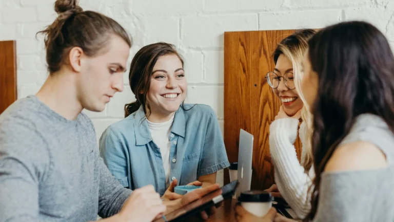 restaurant full of customers which are talking and smiling